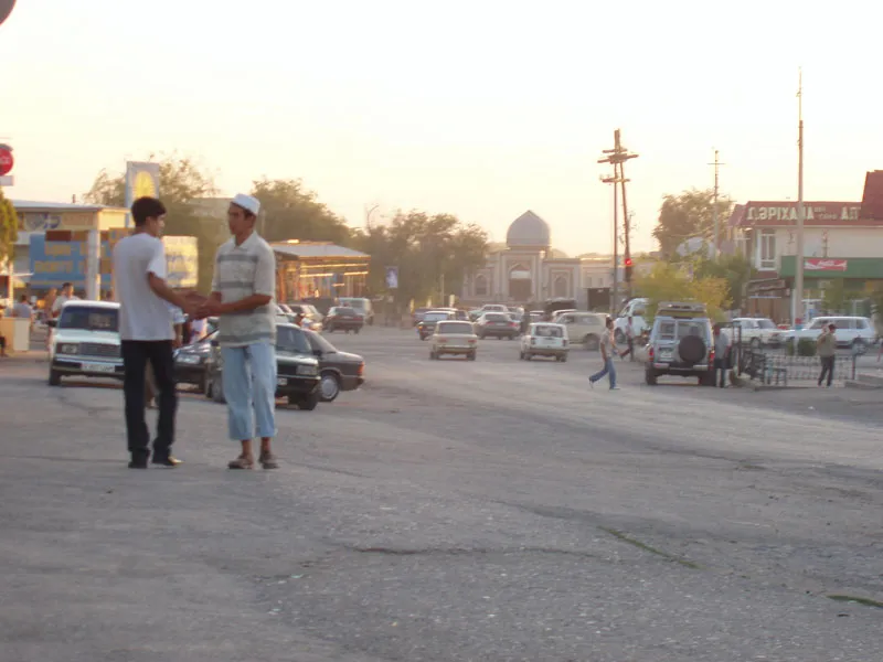 This picture was taken by Michael Hancock in en:July, 2006 in the center of Sayram, Kazakhstan. It shows the crossroads downtown full of traffic on summer afternoon. There are domes visible in the distance belonging to the city's Friday Mosque, and various mausoleums.