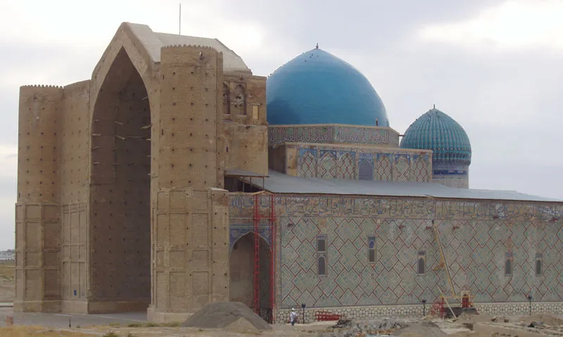 This is a photograph that I [Michael Hancock] took of the Mausoleum of Ahmad Yasavi which stands in Turkestan, Kazakhstan.  Ahmad was born in the city of Sayram in 1103, and after his death was honored with a modest mausoleum.  Amir Temur built this beautiful mausoleum, one of the largest in the world at its time.  The large central blue dome is the largest in Central Asia.