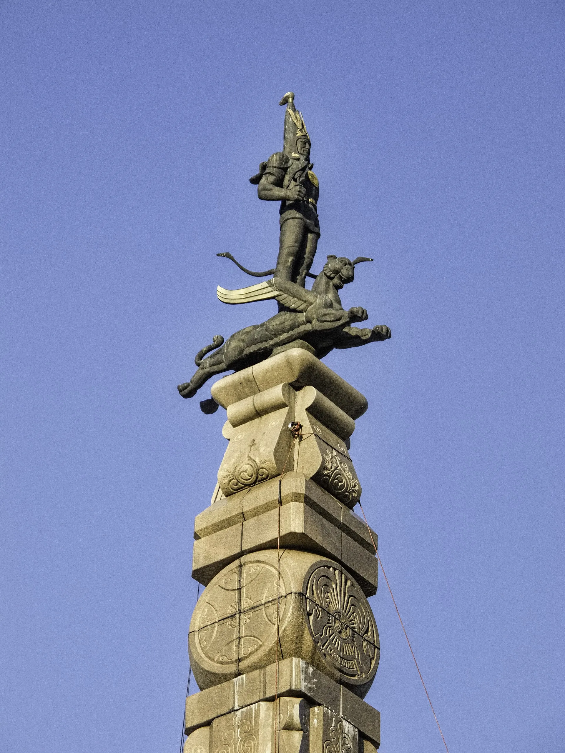 Atop the stone column of the Independence Monument in Republic Square (Respublika Alany) is a replica Golden Man standing on a winged snow leopard. The Golden Man is a warrior’s costume dating from the 5th century BCE made of over 4,000 separate gold pieces which was discovered in 1969 and has become Kazakhstan’s national symbol. (Other items in the tomb suggest to some that it is really a Golden Woman.)
The Kazakhs split off from the Uzbeks in 1468, remained nomadic, and grouped themselves into three ‘hordes.’ The khans of the hordes swore loyalty to the Russian tsar between 1731 and 1742. After the Russian Revolution of 1917 and the rise of the Bolsheviks in 1920, Kazakhstan became first an autonomous republic and then, following a program of forced de-nomadization, became an SSR in 1936. Kazakhstan declared its independence on 16 December 1991, the last Soviet republic to do so.
Almaty was the capital of Kazakhstan from 1927 to 1997. It is the country’s largest city and its bu