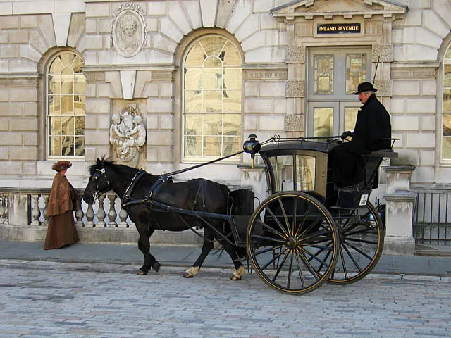 Hansom cab and driver adding character to period filming.
The cab was part of the location filming for the TV movie Sherlock Holmes and the Case of the Silk Stocking (IMDB) at Somerset House in London.